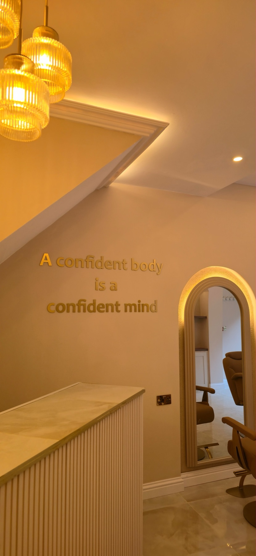 Gold lettering reading 'A confident body is a confident mind'