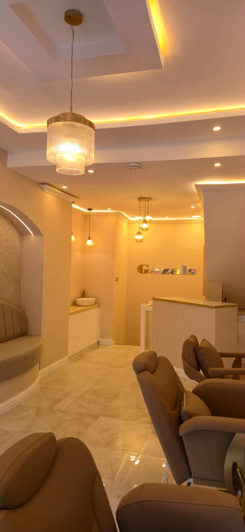 Reception desk beneath the gold Gazals wall sign