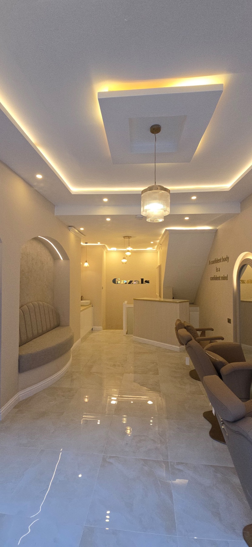 Warm cream reception lounge with gold lighting and marble floor
